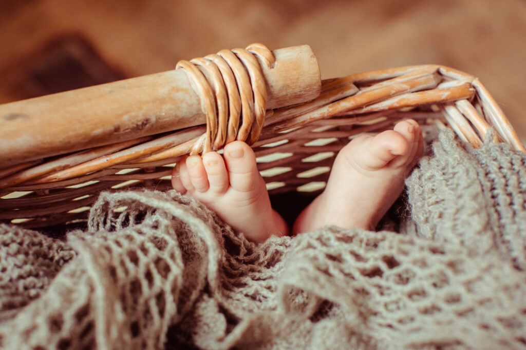 Feet of child lying in the basket